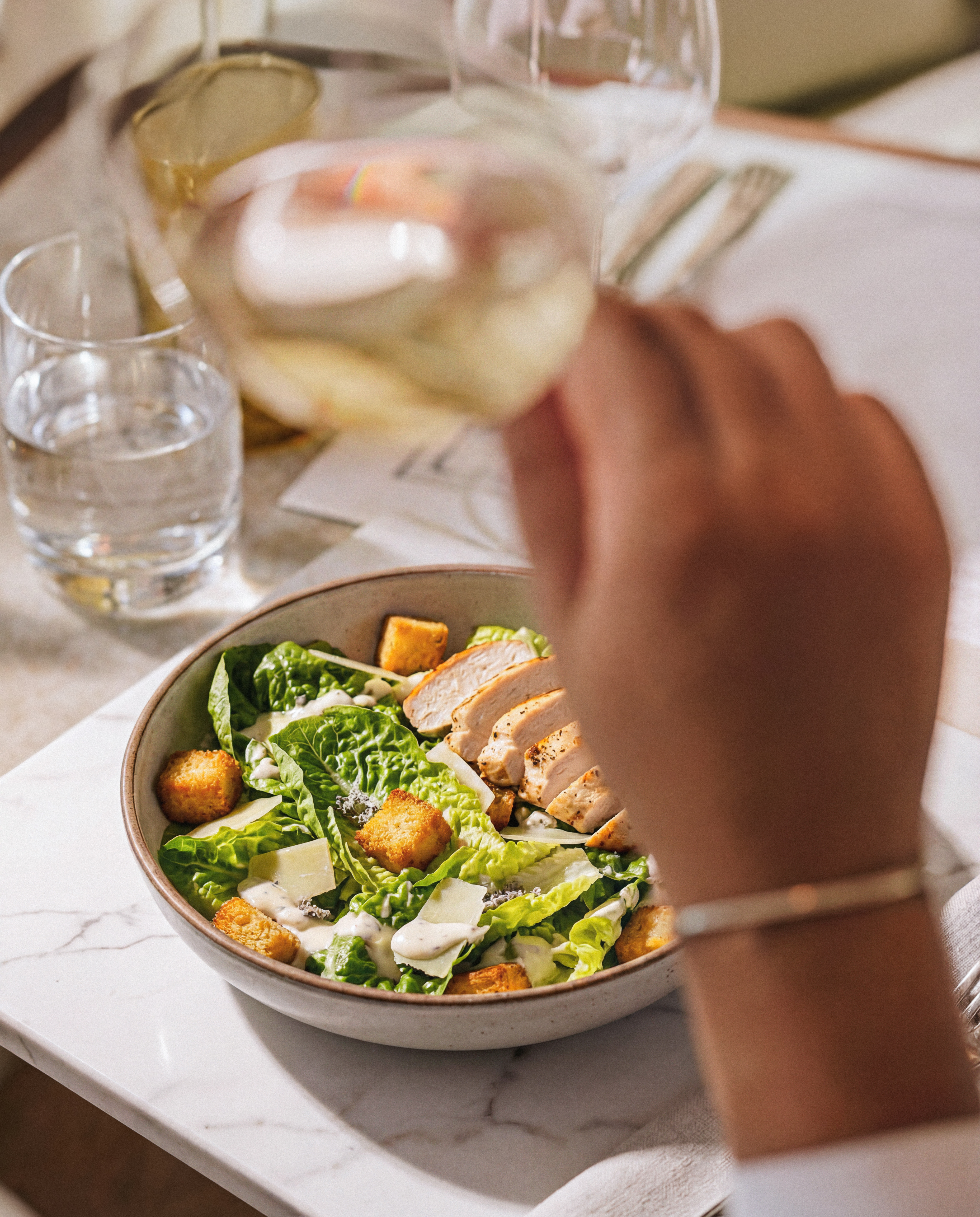 Caesar Salad with crisp romaine, shaved parmesan and golden brioche croutons at Ventura Wynwood